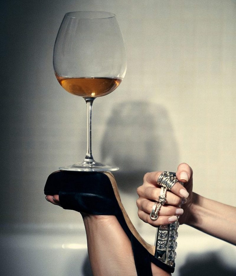 shoe with heel holding a glass of wine. ways to open a bottle of wine