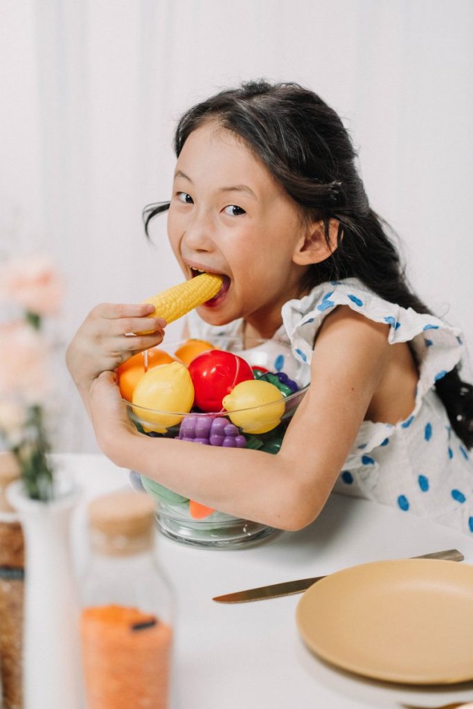 little child eating vegetables