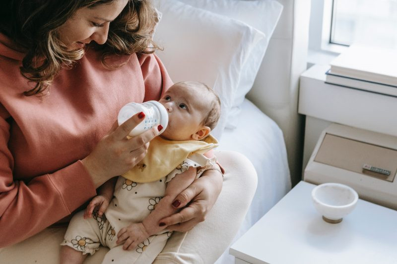 mother bottle feeding her baby 