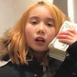 lil tay with a stack of money on her hands