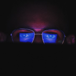 person wearing blue light-blocking glasses