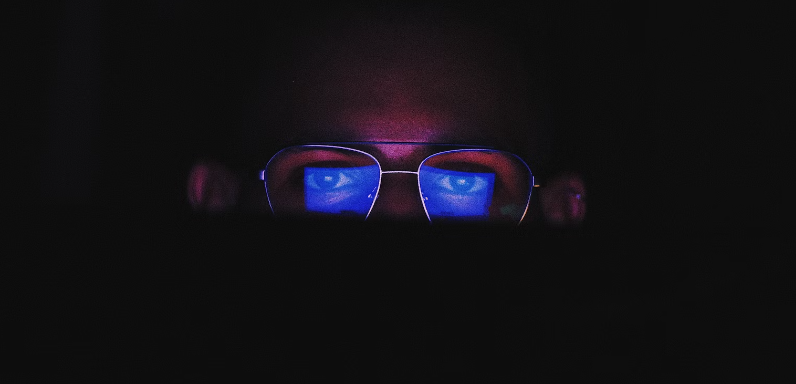 person wearing blue light-blocking glasses