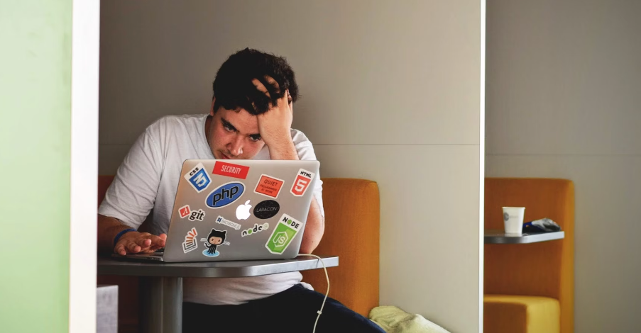 stressed man using macbook