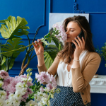 woman smelling houseplant