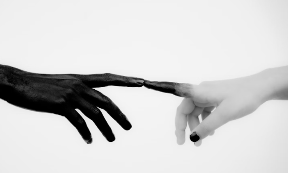 black and white hands touching