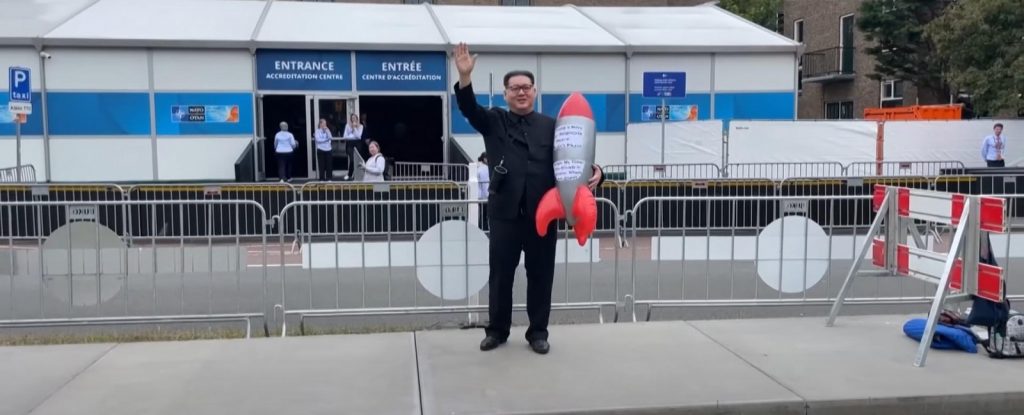 Kim Jong Un Impersonator Howard X in a YouTube video discussing his impact on global politics through satire.